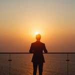 lucid-origin_man_standing_balcony_ocean_horizon_sunrise_suit-7